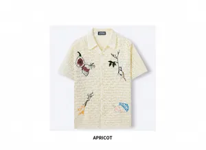 Close-up view of apricot crochet knit shirt featuring detailed floral embroidery patterns