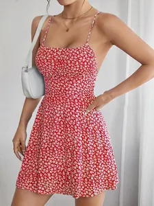 Detailed shot of a stylish red floral spaghetti strap backless mini dress worn by a model