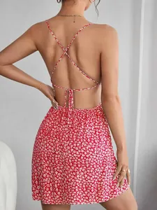 Detail view of a red floral summer dress with sexy crisscross straps and open back