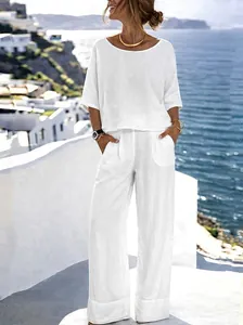 Elegant wit katoenen linnen setje met korte mouwen en wijde pijpen voor vakantie op strand