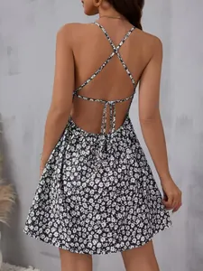 Back view of a floral mini dress with criss-cross straps and open back detail