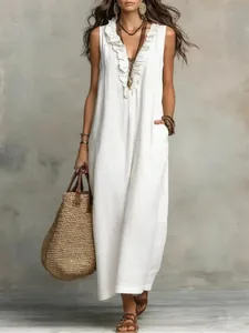 Detailed view of white boho cotton linen dress with ruffled V-neckline and pockets