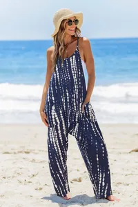 Summer tie-dye sleeveless jumpsuit with pockets shown in a beach setting detail view