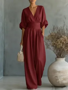 Elegant burgundy wide-leg jumpsuit with deep V-neck and cinched waist design detail