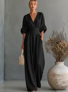 Elegant black V-neck jumpsuit featuring a cinched waist and a wide-leg silhouette