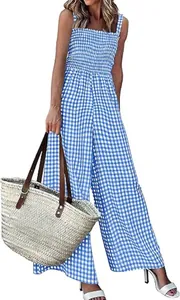 Detail view of blue gingham jumpsuit with wide leg cut and smocked elastic bodice