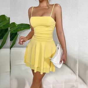 Detail view of a bright yellow ruched spaghetti strap mini dress with a flared skirt