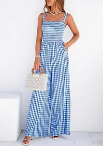 Full view of a blue and white gingham smocked wide-leg jumpsuit shown on a model.