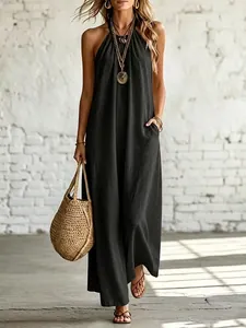 Full-length view of a casual black linen halter maxi dress for women on a model