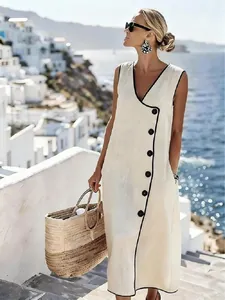 Close-up of the elegant black contrast piping and diagonal buttons on this beige resort dress