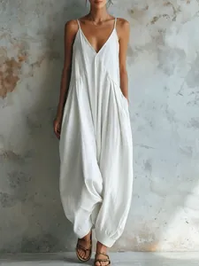 Elegant white deep V neck sleeveless harem jumpsuit for a relaxed summer vacation look