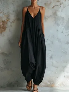 Chic French-style deep V-neck black spaghetti strap jumpsuit with loose lantern leg design