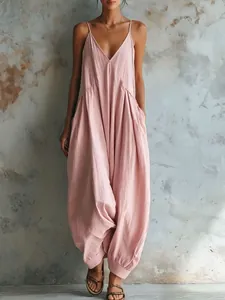 Elegant French style loose dusty pink jumpsuit featuring a deep V-neck and baggy harem pants