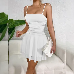 Elegant white ruched mini dress with thin spaghetti straps and stylish tiered skirt detail