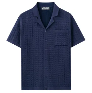 Close-up of a men's dark blue short-sleeved knitted polo shirt with textured chevron knit