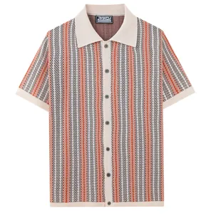 Detailed view of men's short-sleeved jacquard knit polo shirt with orange chevron pattern