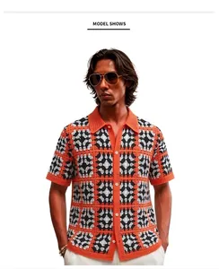 Detail of men's orange and black checkered crochet knit polo shirt with button-up front