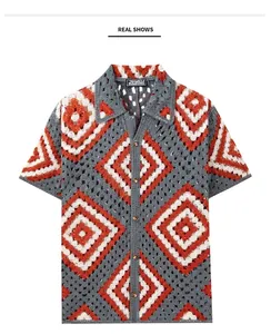 Flat lay of men's geometric crochet knit short sleeve shirt in grey and orange