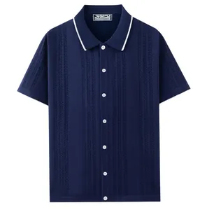 Navy blue short sleeve knit polo shirt with textured vertical pattern and white tipped collar