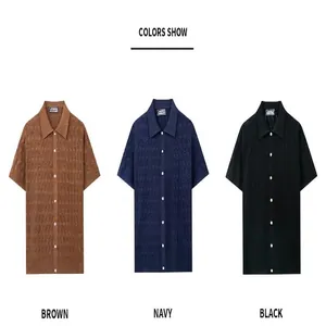 Display of brown, navy, and black men's knit polo shirts with diamond jacquard pattern