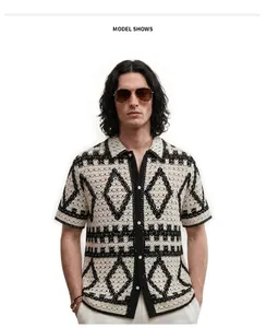 Close-up of men's crochet knit polo shirt featuring a black and white diamond geometric pattern