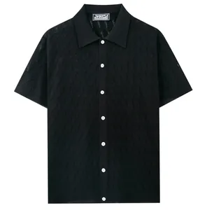 Detailed view of black men's knit polo shirt with intricate hollow diamond pattern