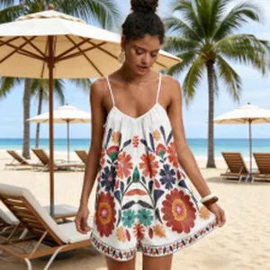 Detailed view of bohemian floral print on white summer romper with thin straps