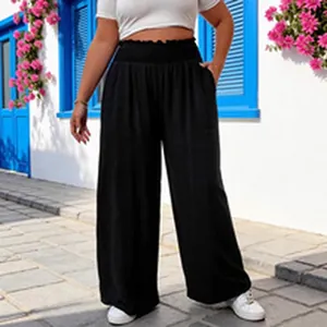 Detail view of white slim crop top paired with black high-waisted wide-leg trousers
