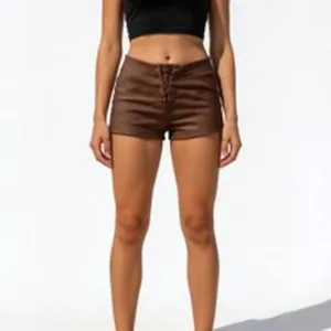 Slim fit brown lace-up faux leather shorts for women with stylish front cross ties