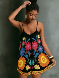 Detail shot of a black camisole dress featuring vibrant ethnic floral prints for summer vacation.