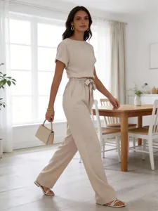Elegant beige short-sleeve jumpsuit with high-waisted wide-leg trousers for summer