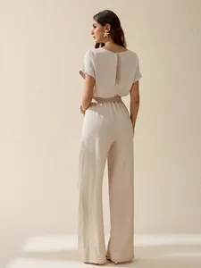 Elegant back view of a beige linen short-sleeve wide-leg jumpsuit for women summer wear