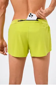 Back view of neon green men's running shorts featuring a functional zipper pocket.