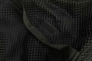 Macro detail of breathable black mesh fabric with hook and loop fastener on outdoor vest
