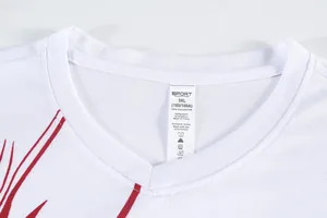 Close-up of white quick-dry sports jersey neckline with 3XL polyester care label