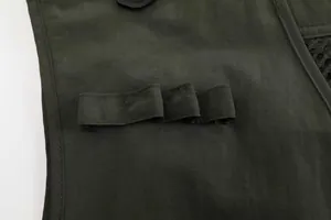 Close-up detail of durable fabric and tool loops on a dark green tactical fishing vest