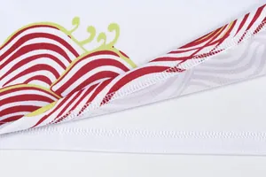 Macro view of quick-dry dragon boat jersey with red wave pattern and neat hem stitching