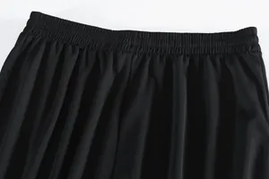 Close-up detail of elastic waistband on black quick-dry athletic mesh shorts.