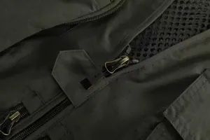 Detail shot of heavy-duty zipper and mesh fabric on olive green fishing vest