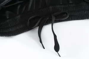 Close-up of black quick-dry sports shorts waistband with adjustable elastic drawstring.