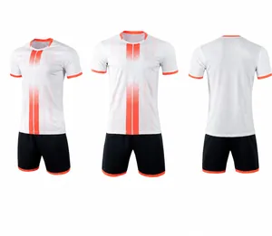 Detailed view of white soccer jersey set with orange stripes and black shorts