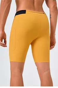 Close-up macro view of mustard yellow quick-dry sports shorts with side pocket for men
