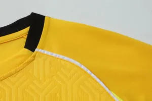 Close-up detail of yellow quick-dry soccer jersey showing fabric texture and collar