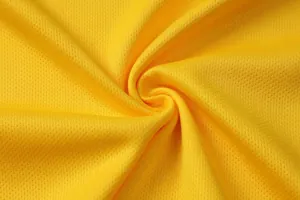 Macro view of yellow quick-dry breathable mesh fabric for football sports jersey detail