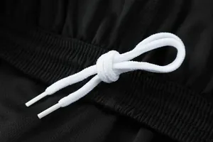 Detailed close-up showing the white drawstring on black breathable soccer shorts