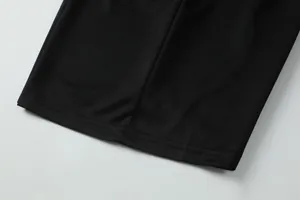 Close-up of double-stitched hem on black quick-dry breathable soccer jersey fabric