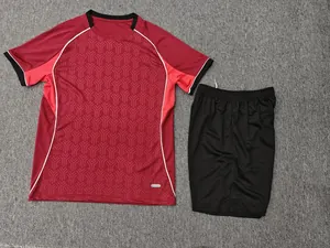 Burgundy and black soccer jersey set with geometric pattern on grey background cloth