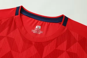 Detail shot of red football jersey collar with breathable jacquard fabric texture
