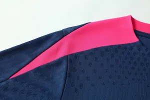 Close-up of breathable fabric texture on navy and pink soccer training jersey