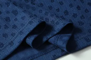 Detailed close-up view of navy blue soccer training jersey fabric with jacquard texture